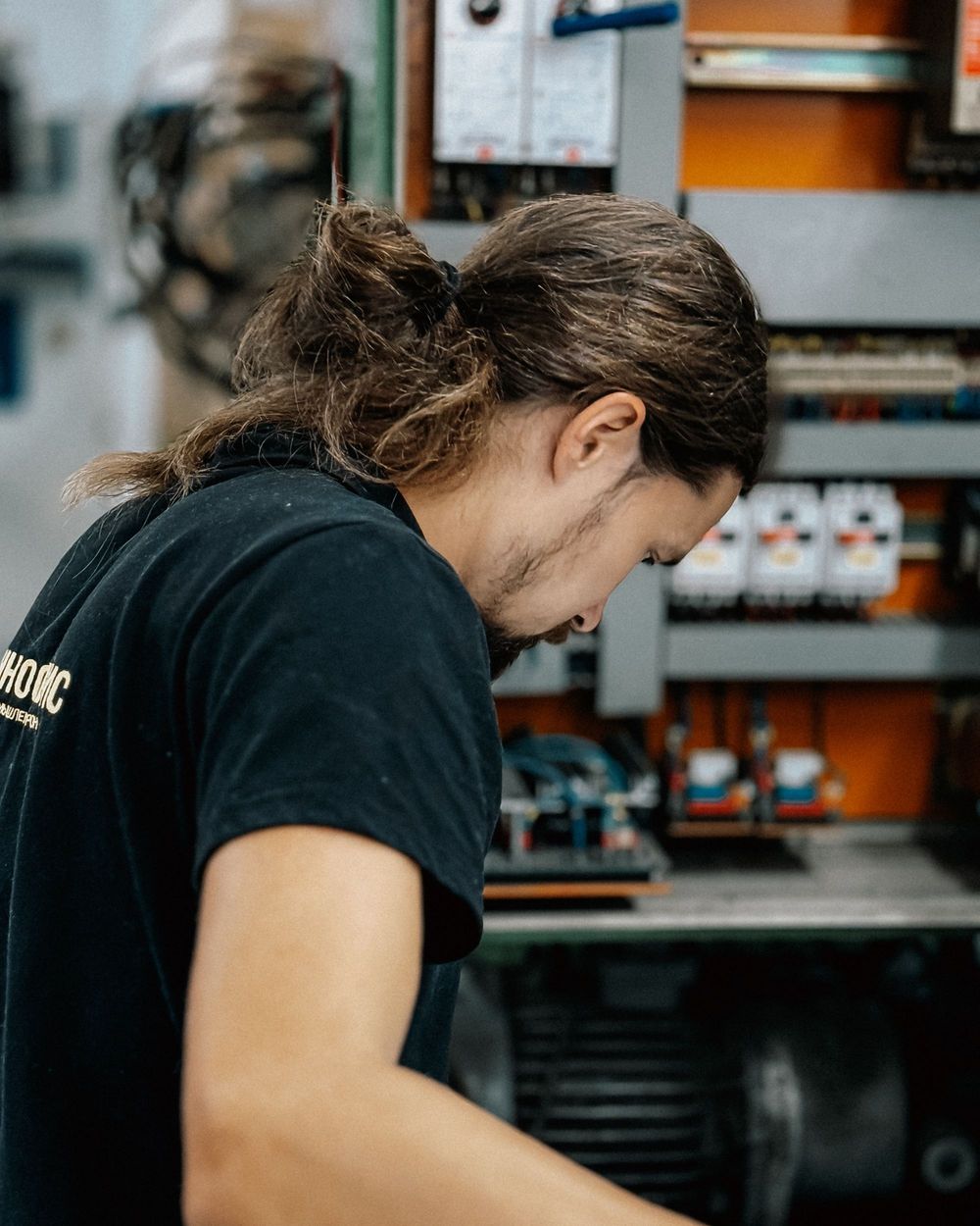 Electrician inspecting an electrical panel
