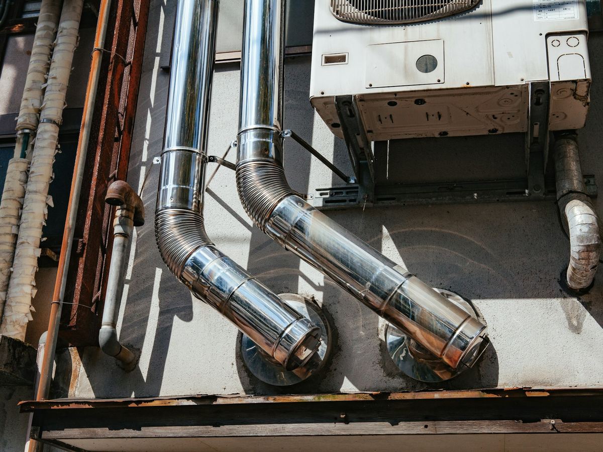 Insulated refrigerant lines and ductwork behind outdoor AC units