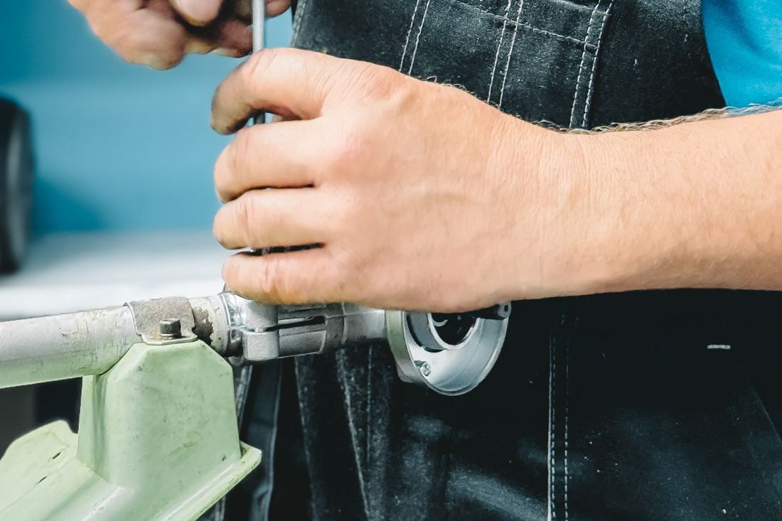 Plumber's hands working on a pipe fitting
